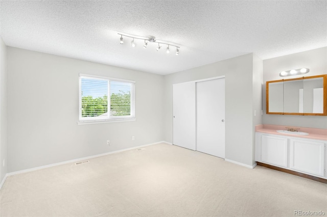 4127 S Lewiston Cir, Aurora, CO 80013 - unfurnished bedroom with light carpet, baseboards, a closet, and a textured ceiling
