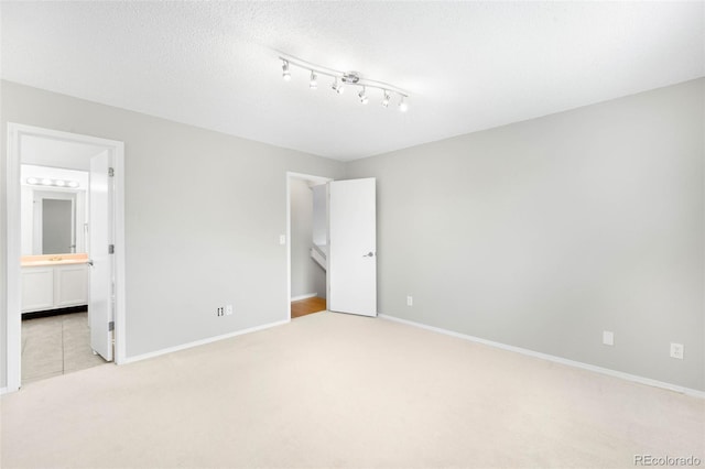 4127 S Lewiston Cir, Aurora, CO 80013 - unfurnished bedroom featuring light colored carpet, baseboards, and ensuite bath