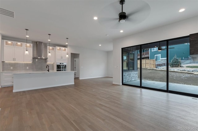 interior space featuring ceiling fan, sink, and light hardwood / wood-style flooring