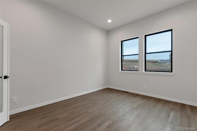 spare room featuring hardwood / wood-style floors