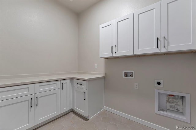 clothes washing area with cabinets, electric dryer hookup, washer hookup, and light tile patterned floors