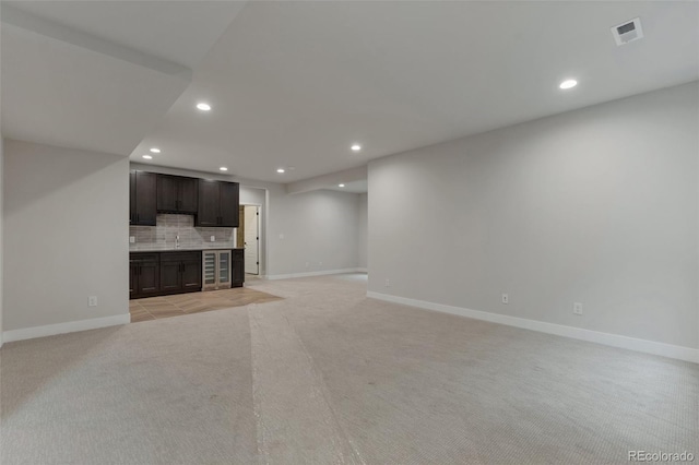 unfurnished living room with light colored carpet and wine cooler