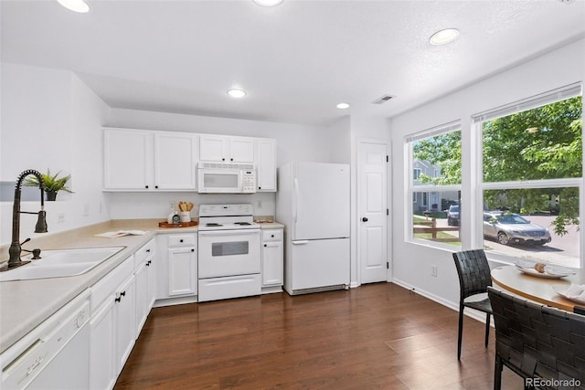 11898 W Tufts Pl, Morrison, CO 80465 - kitchen featuring white appliances, dark wood-type flooring, light countertops, white cabinetry, and recessed lighting