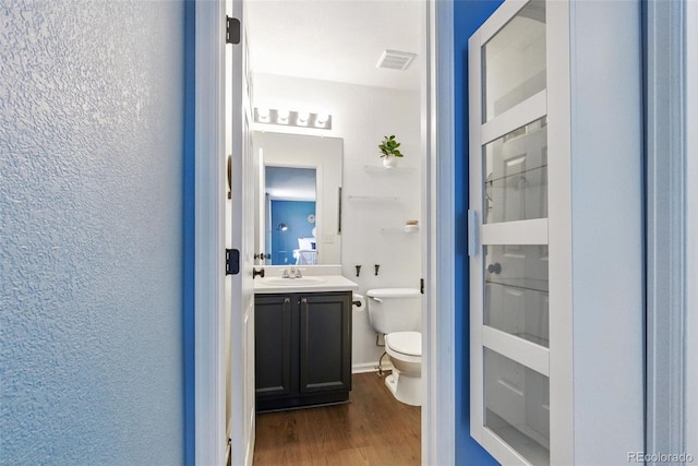 11898 W Tufts Pl, Morrison, CO 80465 - bathroom with vanity, wood finished floors, and a textured wall
