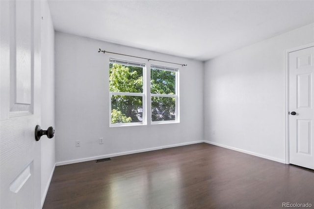 11898 W Tufts Pl, Morrison, CO 80465 - empty room featuring dark wood-style floors and baseboards