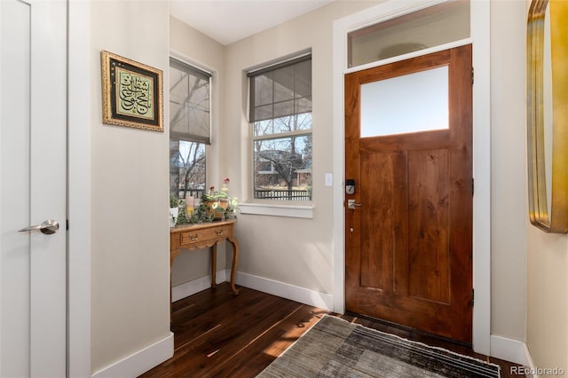 entryway with dark wood-style flooring and baseboards