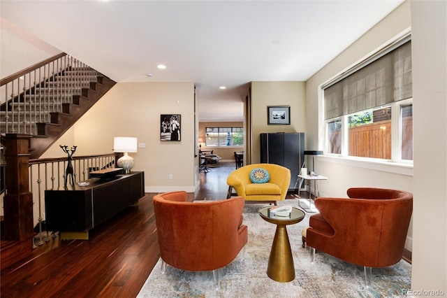 sitting room with wood-type flooring, recessed lighting, baseboards, and stairway