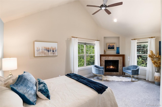 carpeted bedroom with multiple windows, a lit fireplace, high vaulted ceiling, baseboards, and ceiling fan
