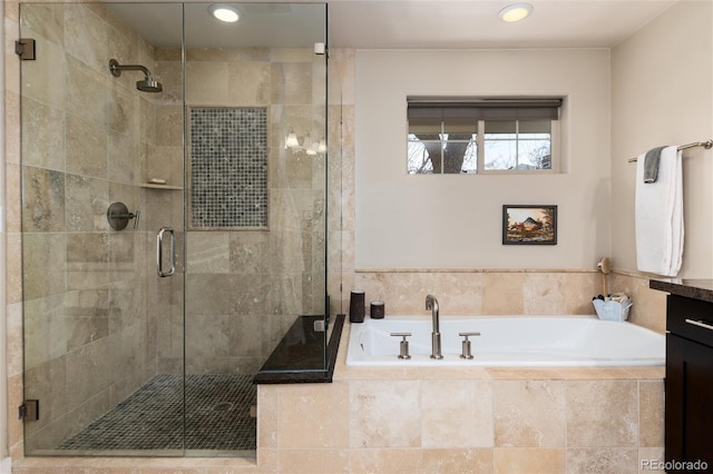 full bath with a stall shower, recessed lighting, and a bath