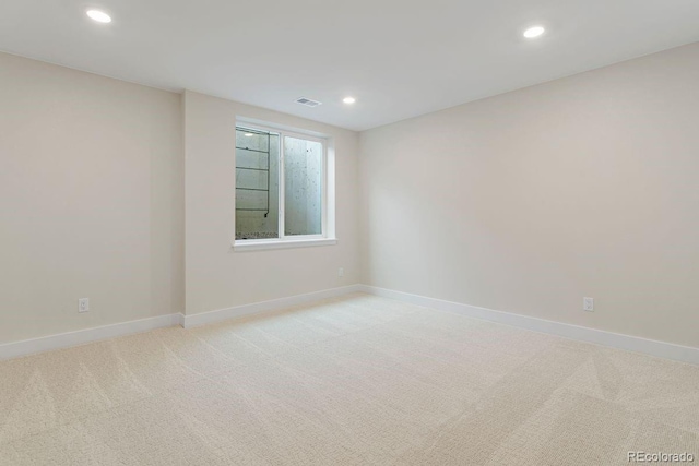 spare room with light colored carpet