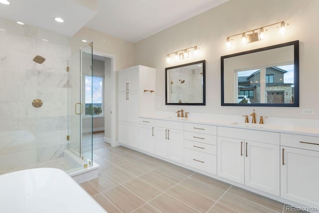 bathroom with tile patterned flooring, shower with separate bathtub, and vanity