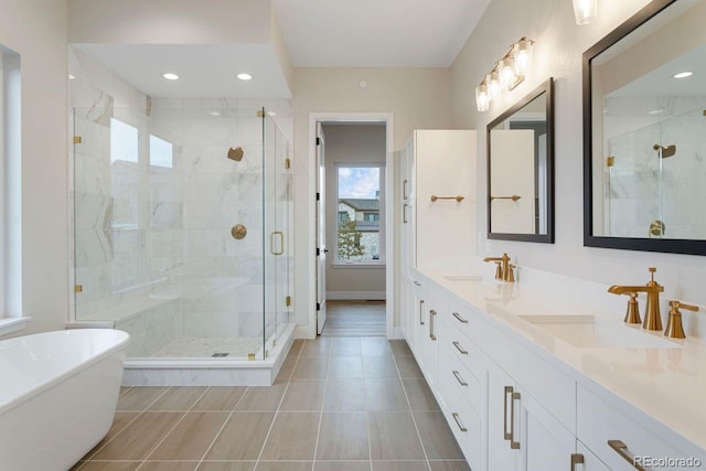 bathroom with tile patterned floors, vanity, and plus walk in shower