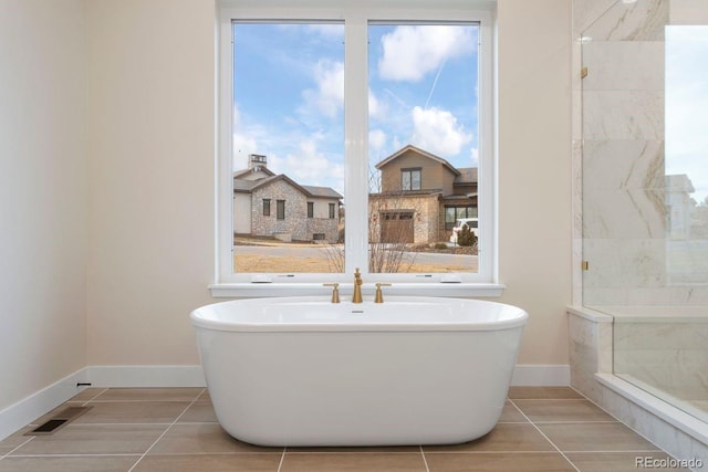 bathroom featuring a bathtub and tile patterned flooring