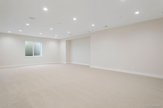 unfurnished room featuring light colored carpet