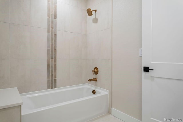 bathroom with tile patterned flooring, vanity, and tiled shower / bath combo