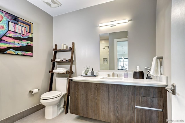 bathroom featuring tile patterned floors, vanity, and toilet