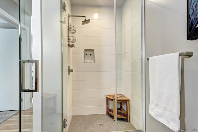 bathroom with an enclosed shower and hardwood / wood-style flooring