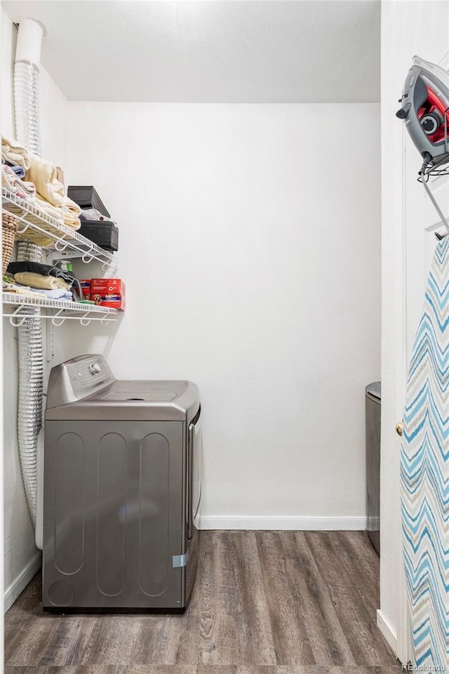 laundry area with dark wood-type flooring and washer / clothes dryer