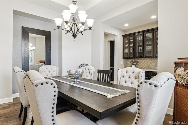 dining area featuring wood-type flooring and a chandelier