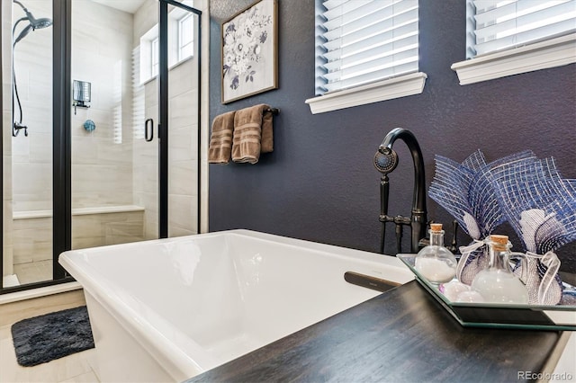 bathroom featuring separate shower and tub