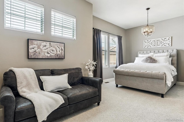 carpeted bedroom featuring an inviting chandelier