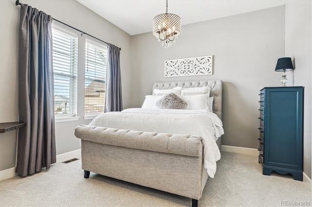 carpeted bedroom with an inviting chandelier