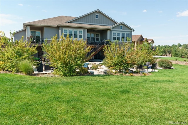 rear view of property featuring a yard and a patio