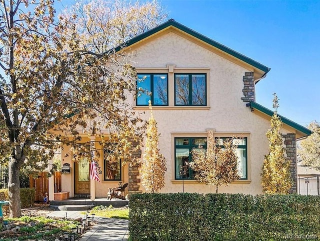 back of property featuring stucco siding
