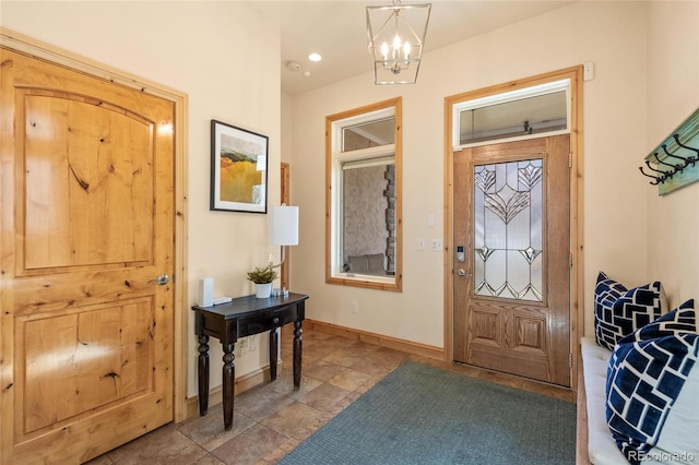 foyer featuring a notable chandelier and baseboards