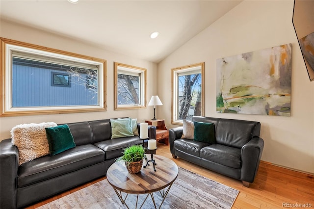living area with recessed lighting, lofted ceiling, and wood finished floors