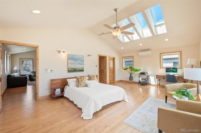 bedroom with a skylight, a wall unit AC, high vaulted ceiling, and multiple windows