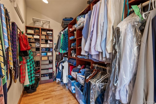 spacious closet featuring vaulted ceiling and wood finished floors