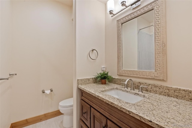 bathroom featuring toilet and vanity