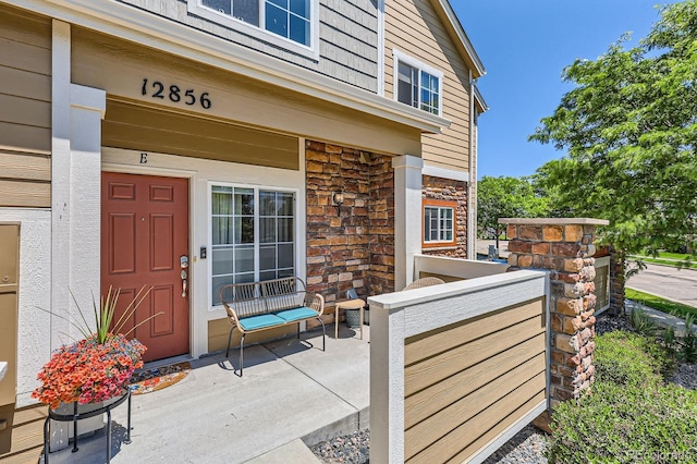 12856 Jasmine St Unit E, Thornton, CO 80602 - entrance to property with stone siding and a porch