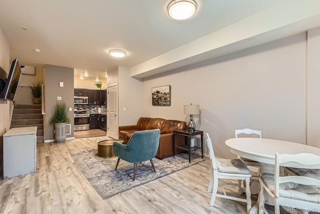 12856 Jasmine St Unit E, Thornton, CO 80602 - living area with light wood-type flooring and stairway