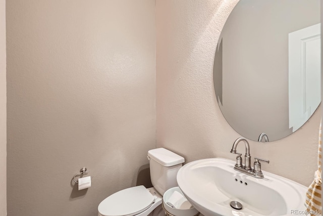 12856 Jasmine St Unit E, Thornton, CO 80602 - half bathroom featuring a sink and toilet