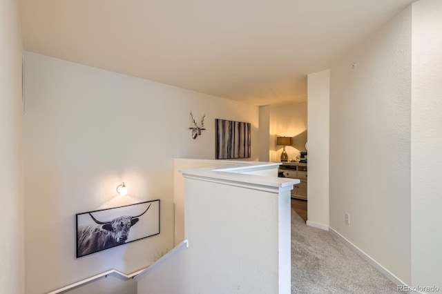 12856 Jasmine St Unit E, Thornton, CO 80602 - hallway featuring an upstairs landing and light carpet