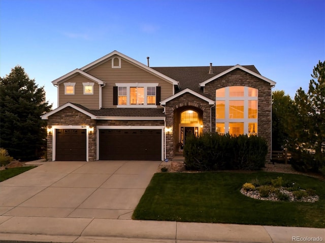 view of front facade with a garage and a lawn