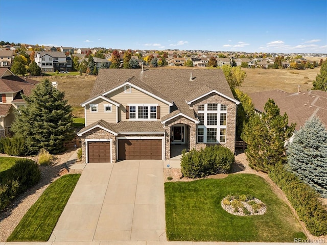 view of front of property with a garage and a front lawn