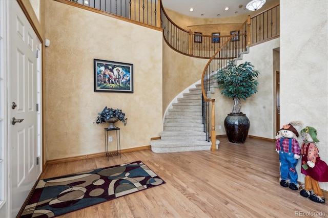 entrance foyer with hardwood / wood-style flooring and a high ceiling