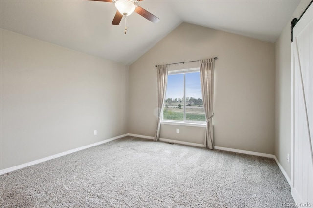 unfurnished room featuring carpet floors, ceiling fan, baseboards, and vaulted ceiling
