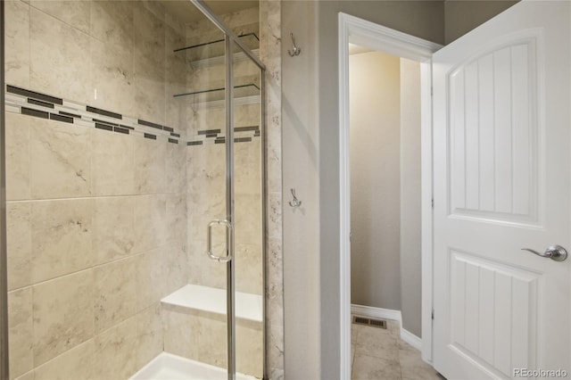 full bathroom featuring baseboards, visible vents, and a shower stall