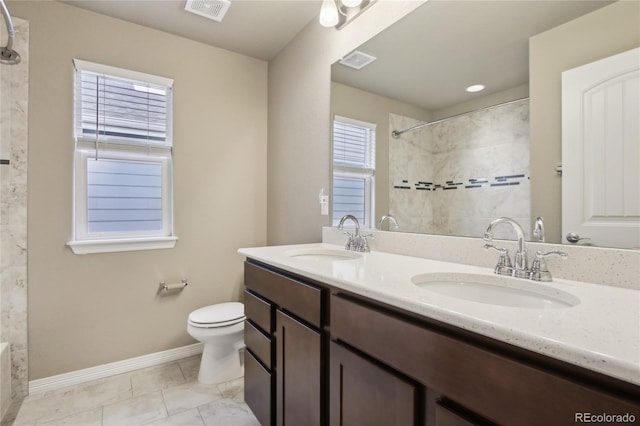 full bathroom with toilet, visible vents, and a sink