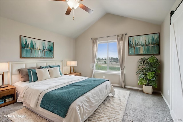 bedroom with baseboards, carpet flooring, a barn door, and lofted ceiling