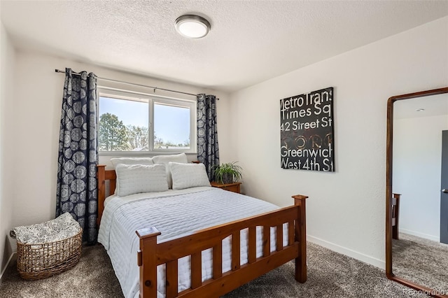 bedroom featuring a textured ceiling, baseboards, and carpet