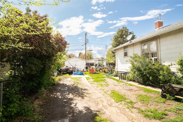 2235 Eaton St, Edgewater, CO 80214 - view of yard featuring dirt driveway and an outdoor structure