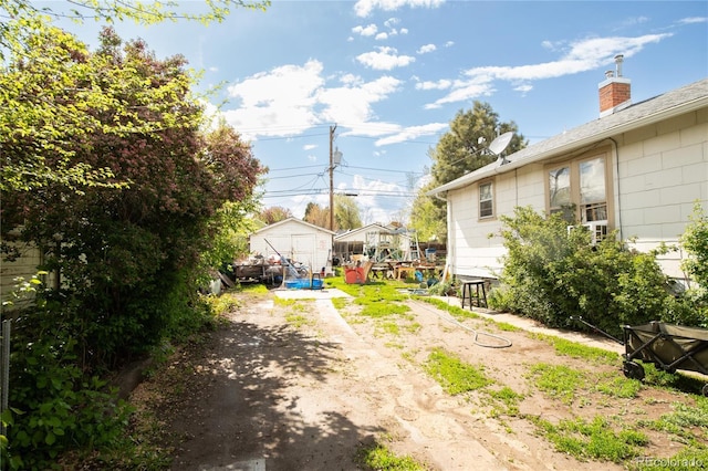 2235 Eaton St, Edgewater, CO 80214 - view of yard featuring dirt driveway, an outdoor structure, and a shed