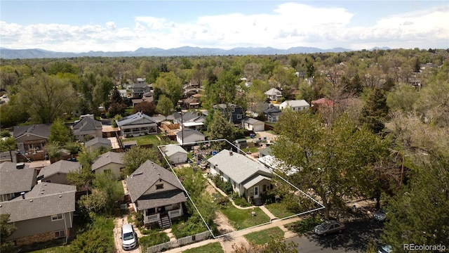2235 Eaton St, Edgewater, CO 80214 - aerial perspective of suburban area featuring property parcel outlined, a mountain backdrop, and a forest