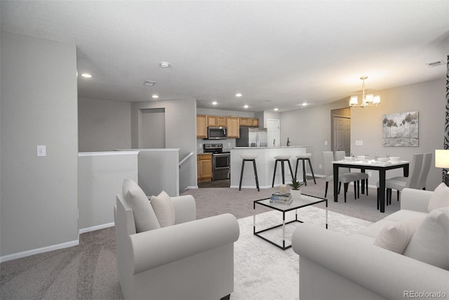 carpeted living room with a chandelier