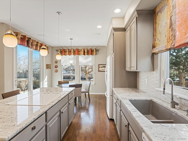 kitchen with sink, gray cabinetry, hanging light fixtures, tasteful backsplash, and black electric cooktop